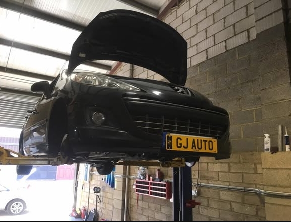 GJ Auto workshop with vehicle on lift